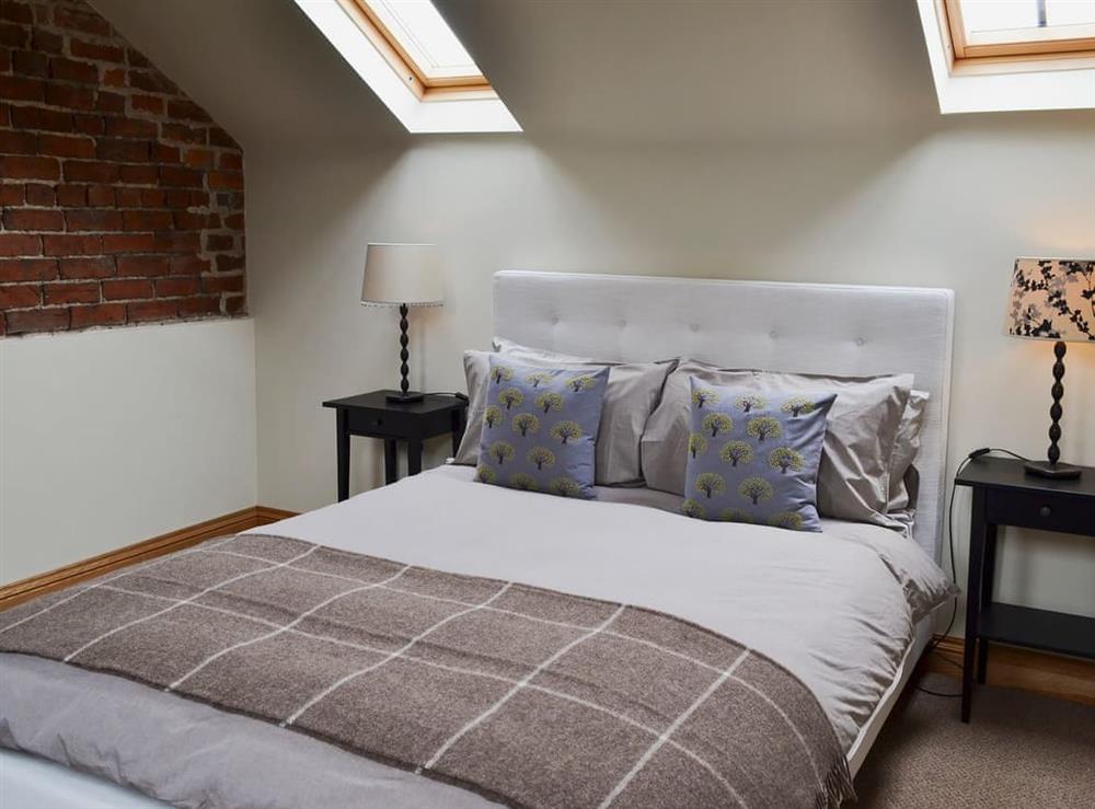 Stylish double bedroom with kingsize bed at Mullins Cottage, 