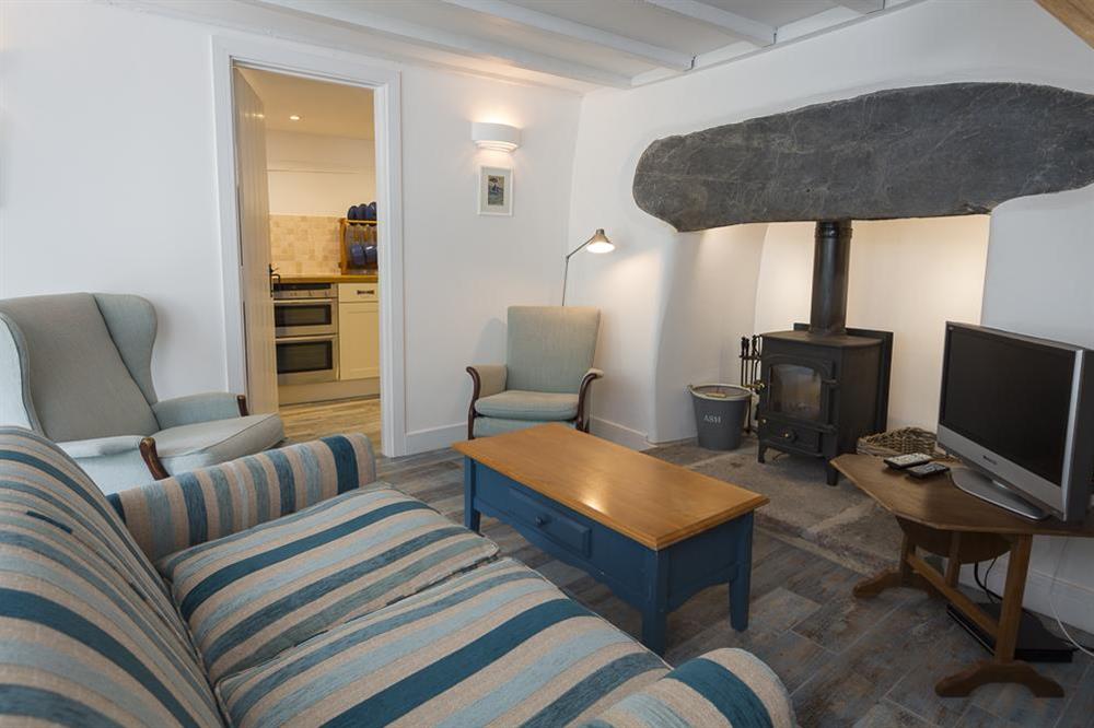 Cosy sitting and dining room with wood burning stove at Lee Cottage in , Stokenham, Kingsbridge