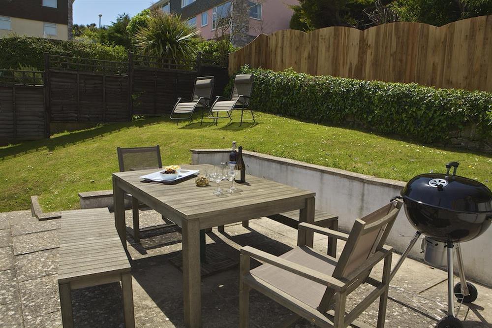 Sloping rear garden, sunny terrace with garden furniture and barbecue at Leylands in Allenhayes Road, Salcombe