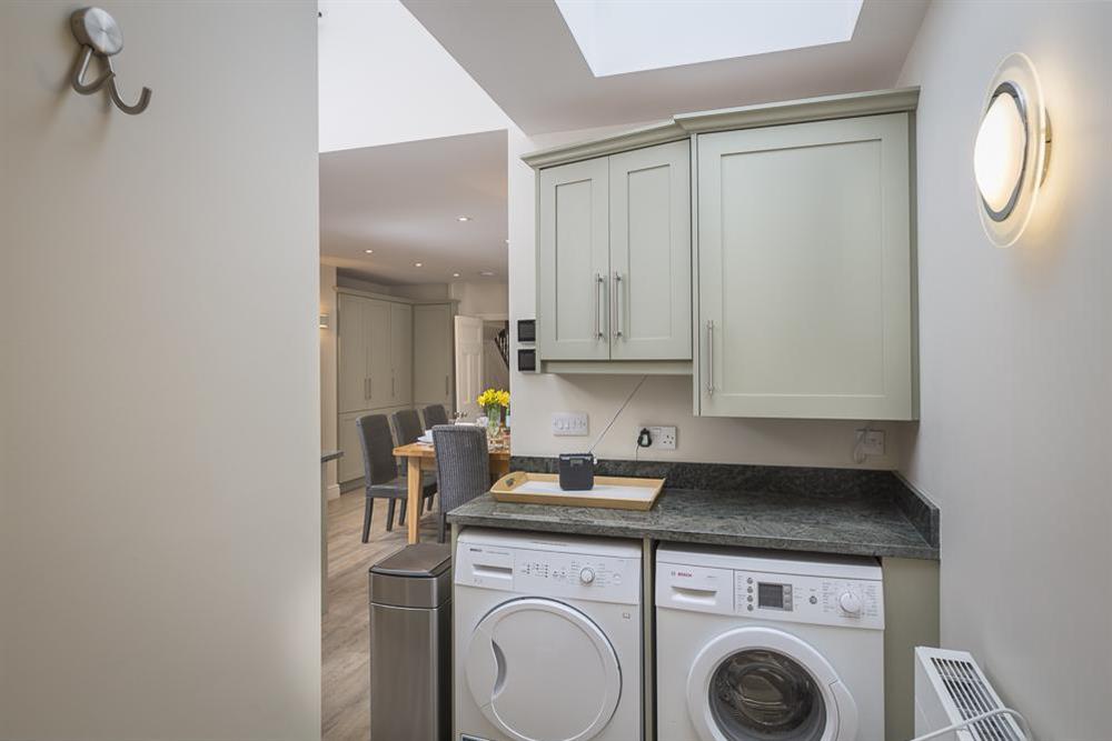 Utility room with washing machine and tumble drier at Leylands in Allenhayes Road, Salcombe