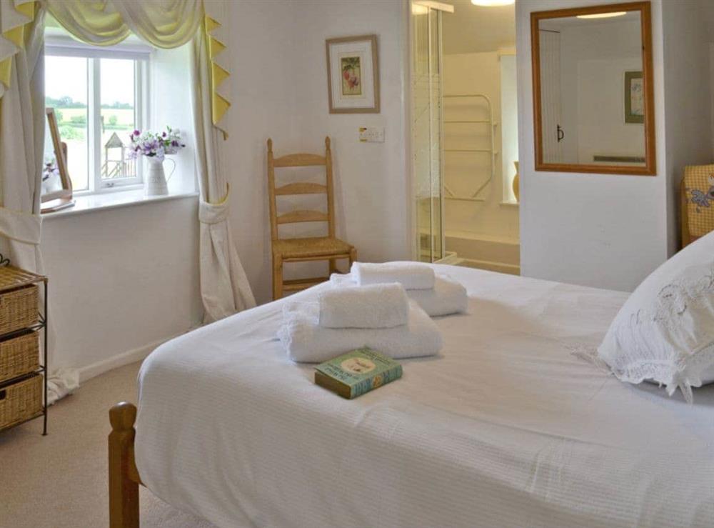 Comfortable double bedroom with en-suite shower room at Badgers House, 