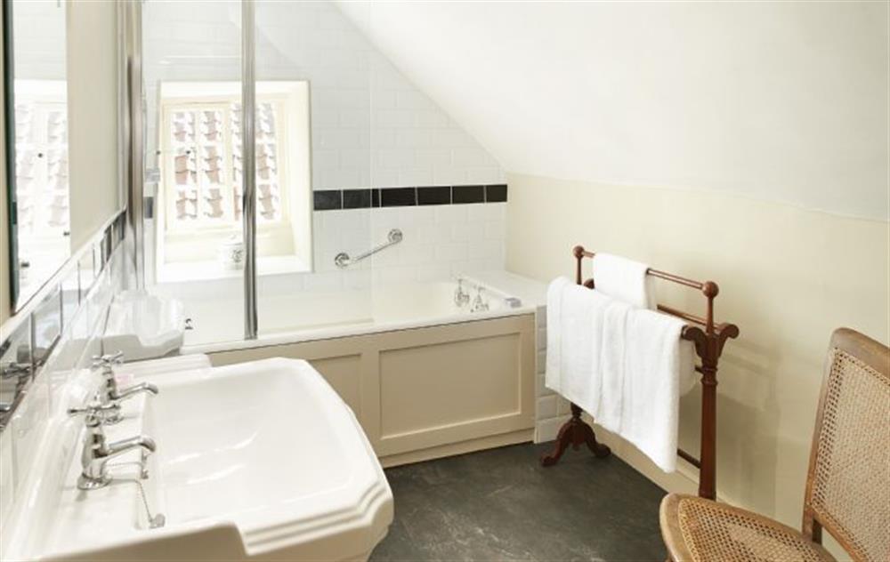 Contemporary bathroom with bath and over bath shower at Librarians Cottage, Coneysthorpe