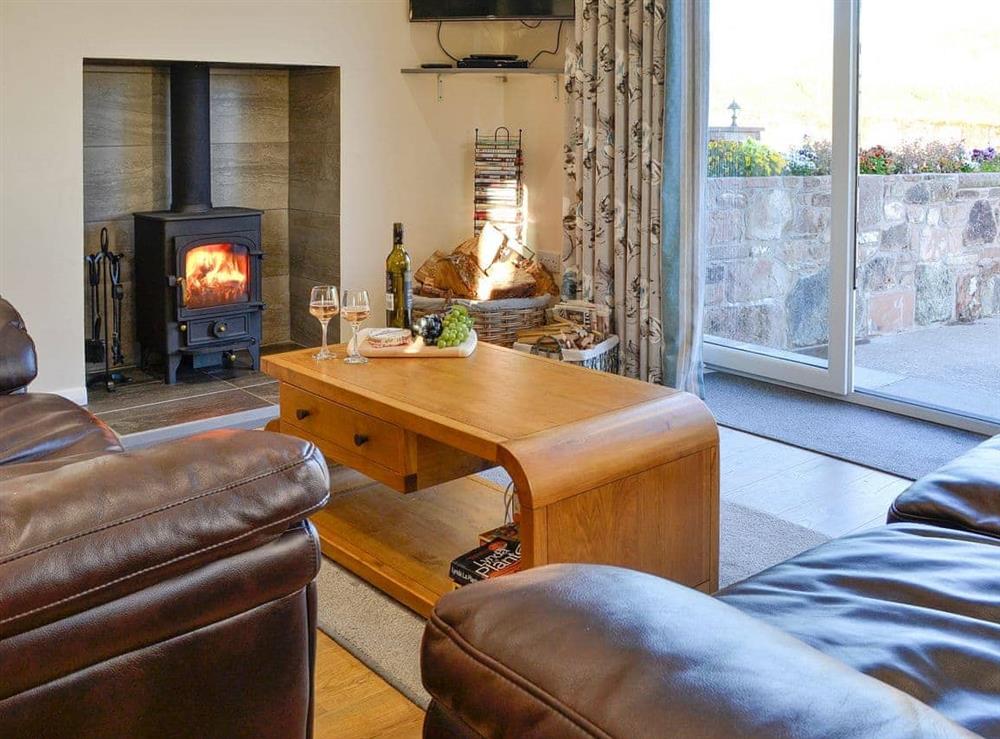 Lovely and welcoming living area with patio doors to the courtyard at Liftingstane Dairy Cottage, 