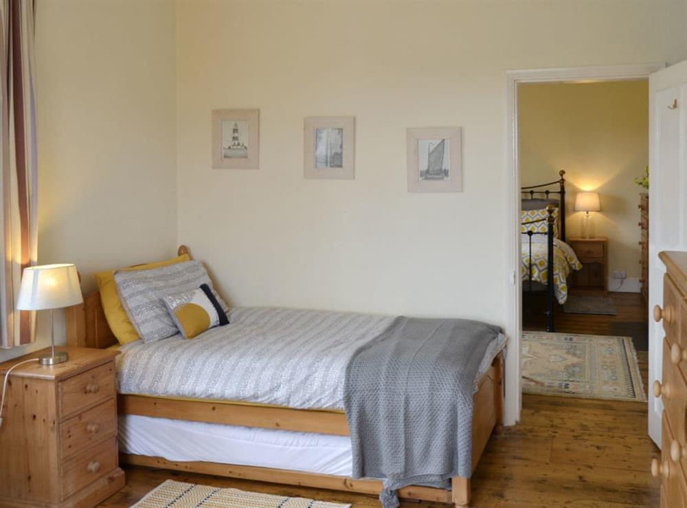Twin bedroom with connecting door to double bedroom at Lighthouse Cottage in Happisburgh, Nr Cromer, Norfolk., Great Britain