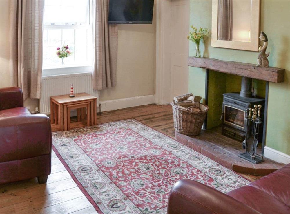 Welcoming living room with wood burner at Lighthouse Cottage in Happisburgh, Nr Cromer, Norfolk., Great Britain