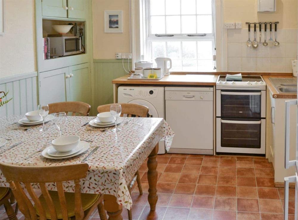 Well-equipped kitchen with dining area at Lighthouse Cottage in Happisburgh, Nr Cromer, Norfolk., Great Britain