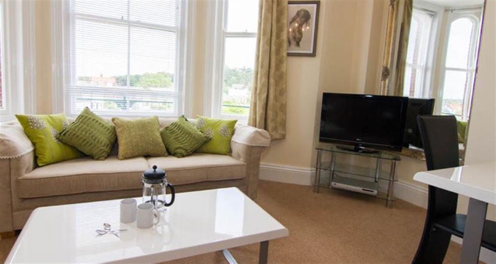 First floor:  Sitting area with comfy sofa and flatscreen television at Lighthouse View, Cromer