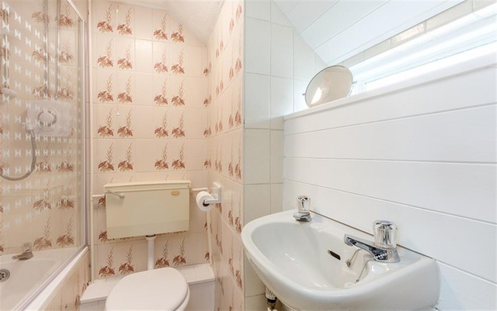 Family bathroom with shower over bath at Lilac Cottage in Axminster