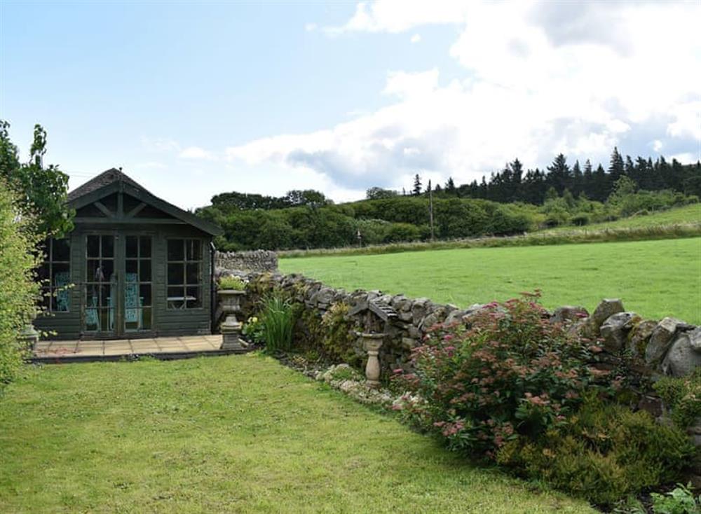 Lawned garden with summerhouse at Lilac Cottage in Westgate, near Bishop Auckland, Durham