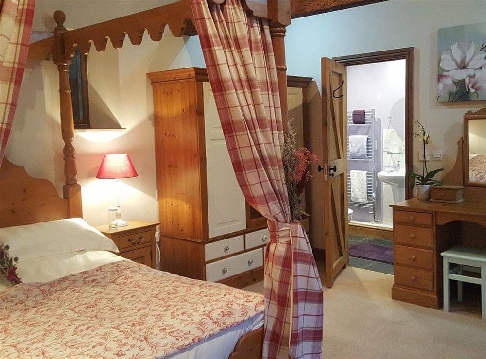 Four Poster bedroom at Lily Rose Cottage in Gilsland, near Brampton, Cumbria