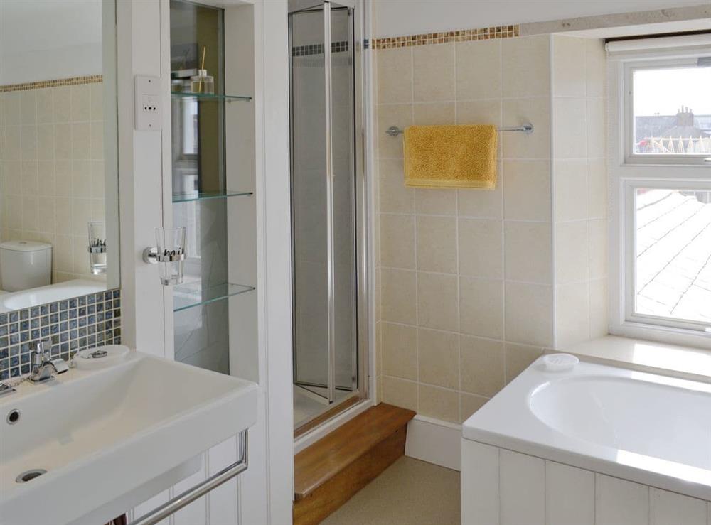 Family bathroom with bath and separate shower cubicle at Lime Cottage in Portland, near Weymouth, Dorset