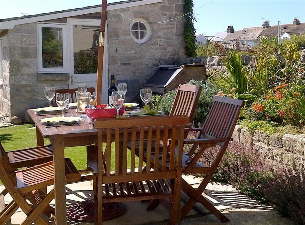 Sitting out area in mature garden at Lime Cottage in Portland, near Weymouth, Dorset