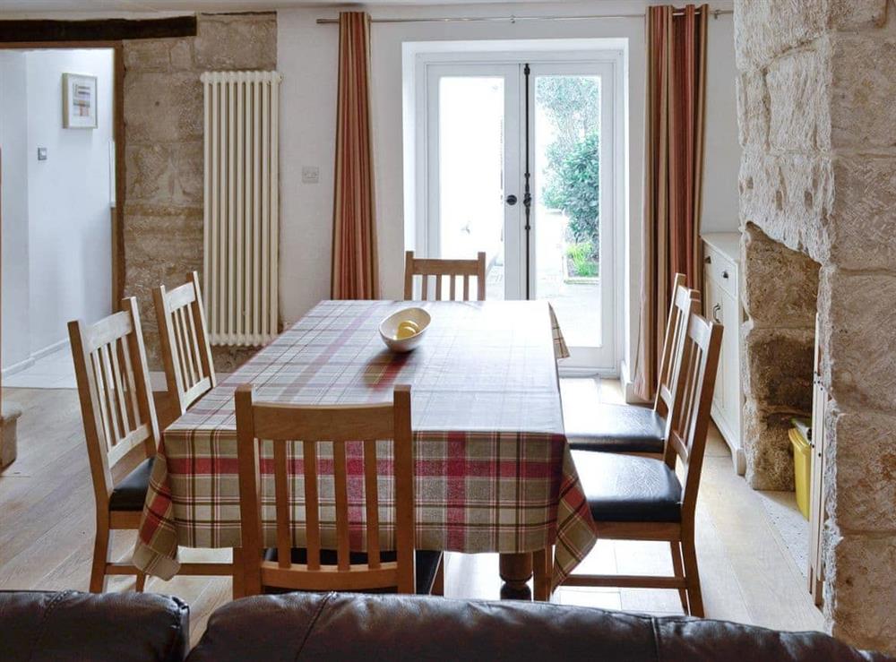 Spacious dining room with access to stairs, kitchen and French doors to garden at Lime Cottage in Portland, near Weymouth, Dorset