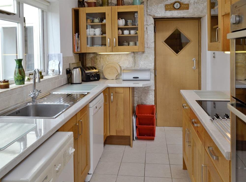 Well-equipped galley style kitchen at Lime Cottage in Portland, near Weymouth, Dorset