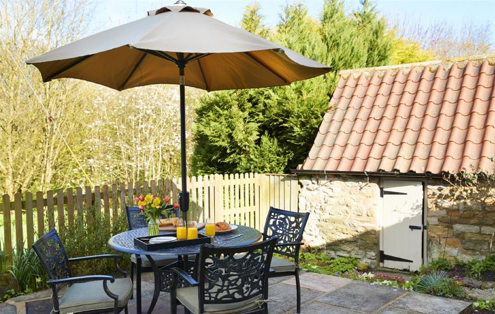 Enjoy a leisurely breakfast on the private patio at the rear of the garden at Lime Kiln Farmhouse, Coneysthorpe