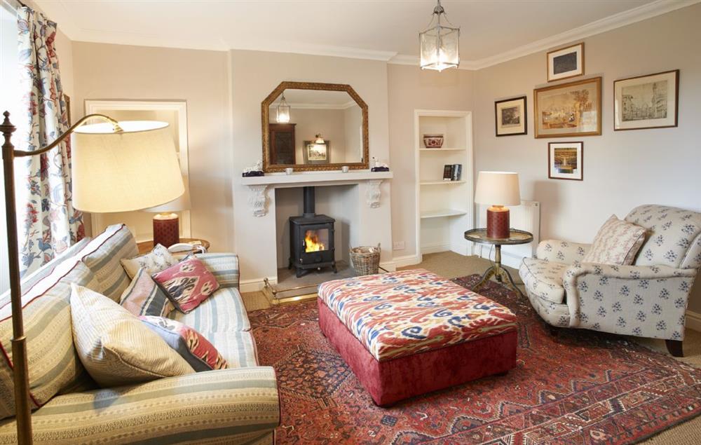 Sitting room with wood burning stove and furnished with carefully chosen pieces from  Castle Howard itself