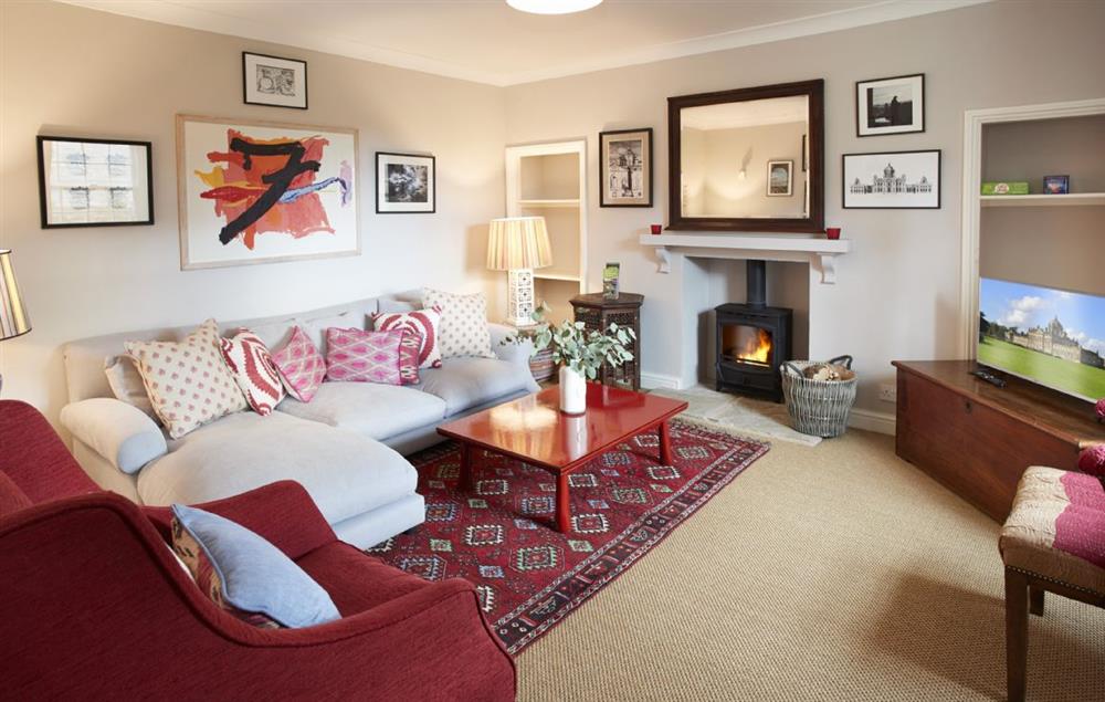 Snug/TV room with wood burning stove, relax on the comfortable L-shaped sofa at Lime Kiln Farmhouse, Coneysthorpe