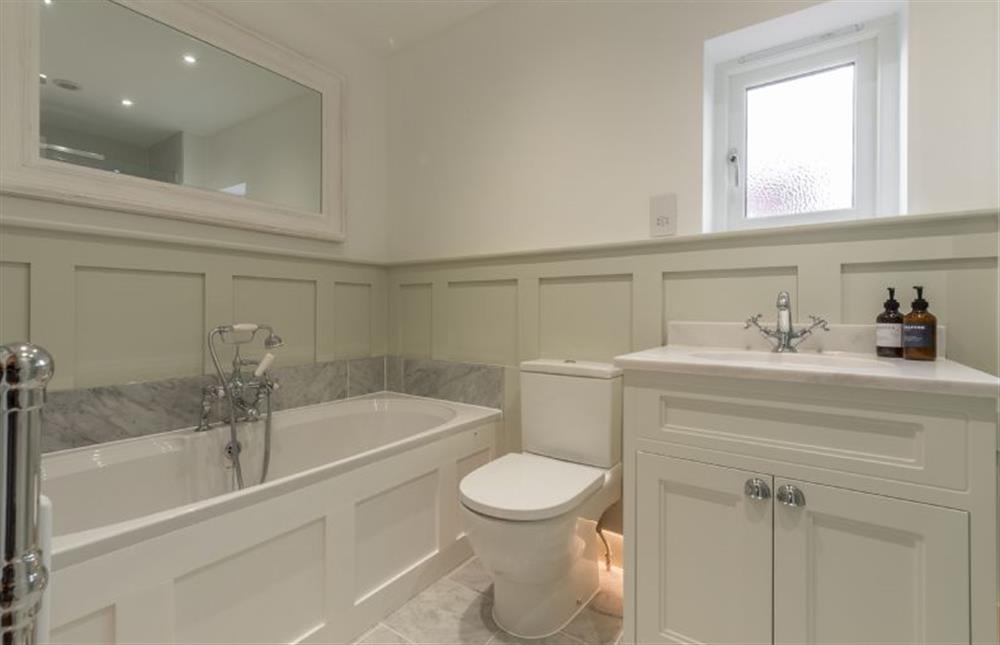 First floor: Bedroom two en-suite has bath and separate shower at Limestone House, Burnham Market