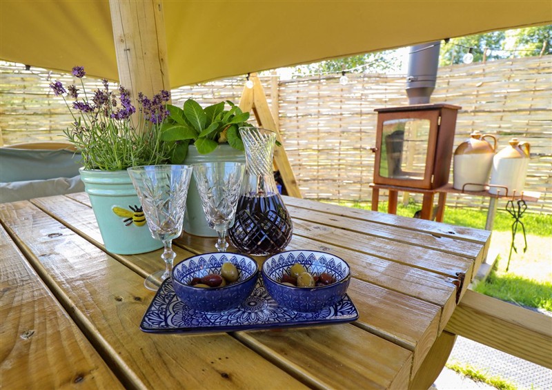 Enjoy a glass of wine on the patio at Limetree Luxury Glamping Portland, Nottingham
