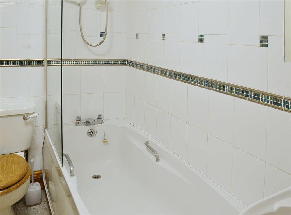 The fully tiled bathroom has a shower over the bath at Limpet Cottage in Boulmer, Northumberland