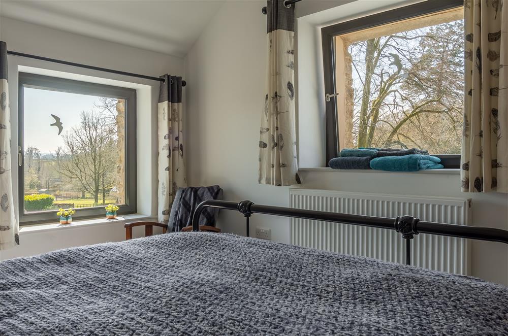 Bedroom three with double aspect countryside views at Linden Barn, Orton