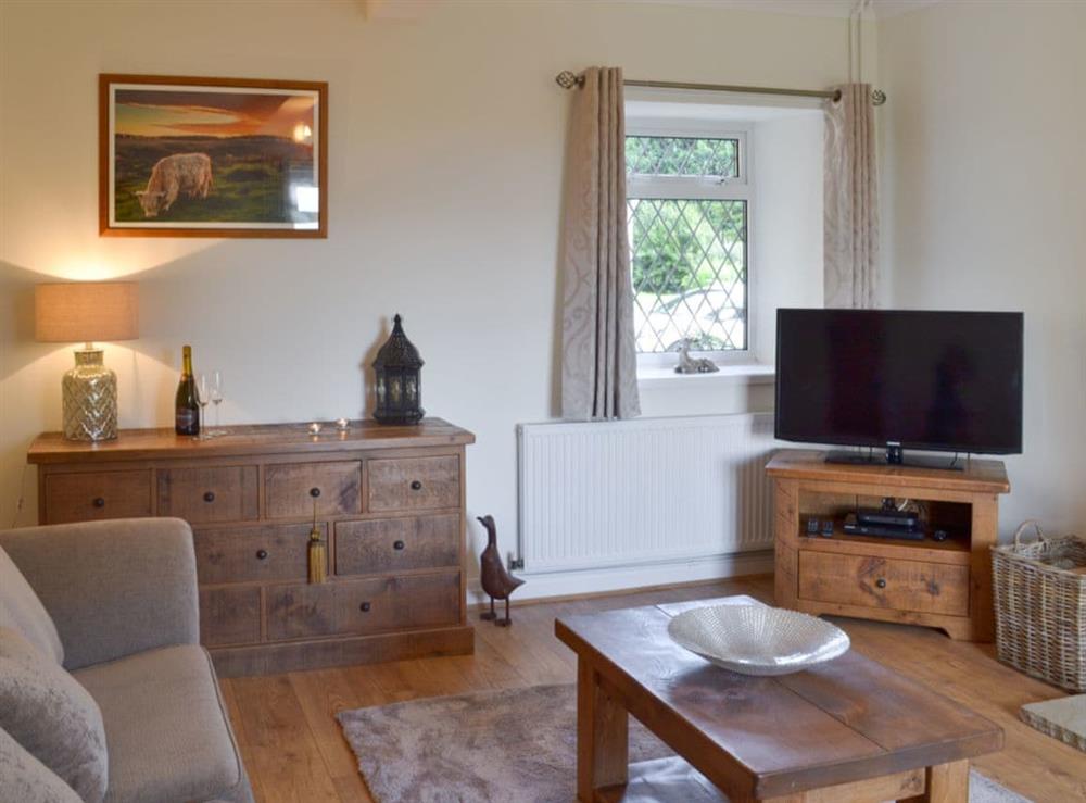 Cosy living room with TV at Lings Farm Cottage in Temple Normanton, near Chesterfield, Derbyshire
