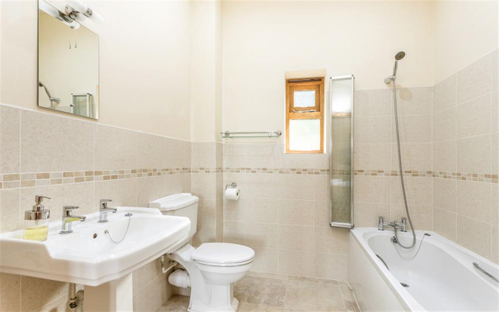 Bathroom with shower over bath en=suite to bedroom 2  at Linhay in Ottery St Mary