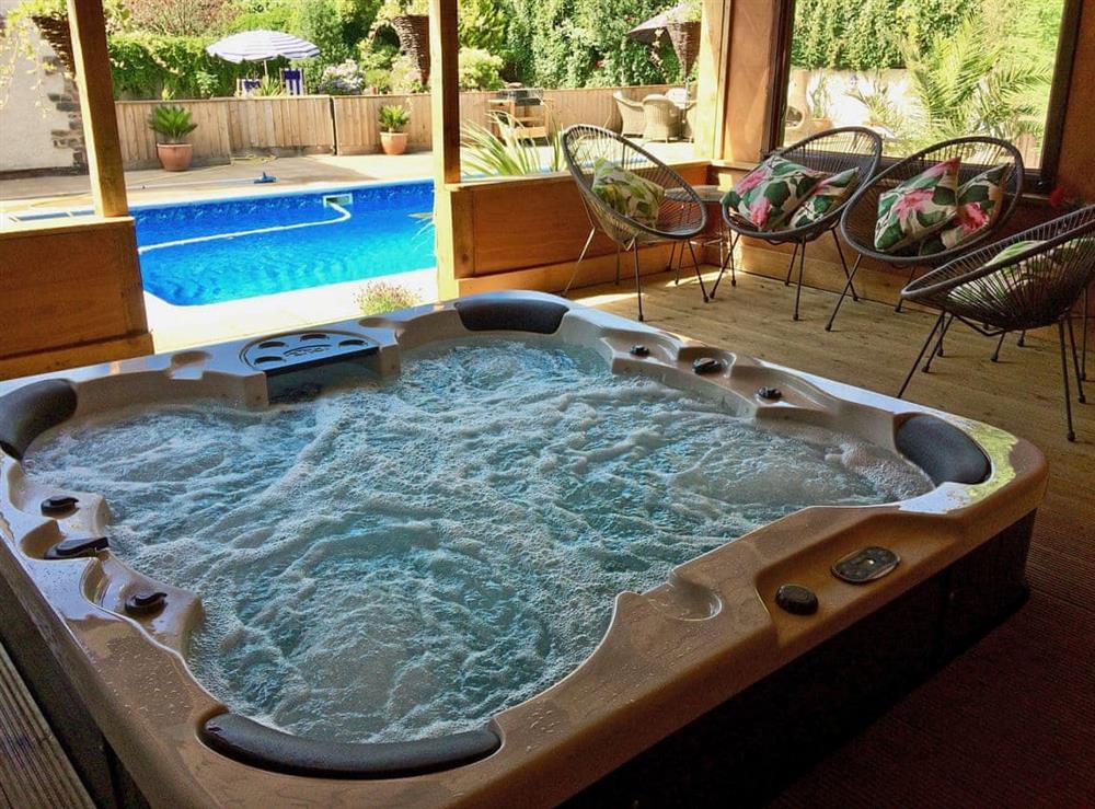 Relaxing hot tub with seating area at Linnets in Fitzhead, nr Wivelscombe, Somerset
