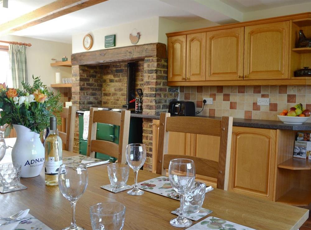Large farmhouse style kitchen with an Aga and huge dining table at Linton Woods Farm in Linton-on-Ouse, near York, North Yorkshire
