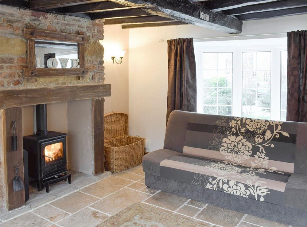Exposed wood beams and feature fireplace in living room at Listers Lodge in Brotton, near Saltburn-by-the-Sea, Cleveland