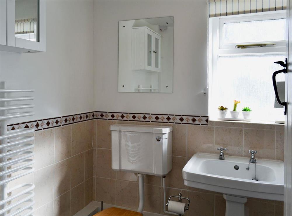 Bright spacious bathroom with heated towel rail at Little Birketts Cottage in Holmbury St Mary, near Dorking, Surrey