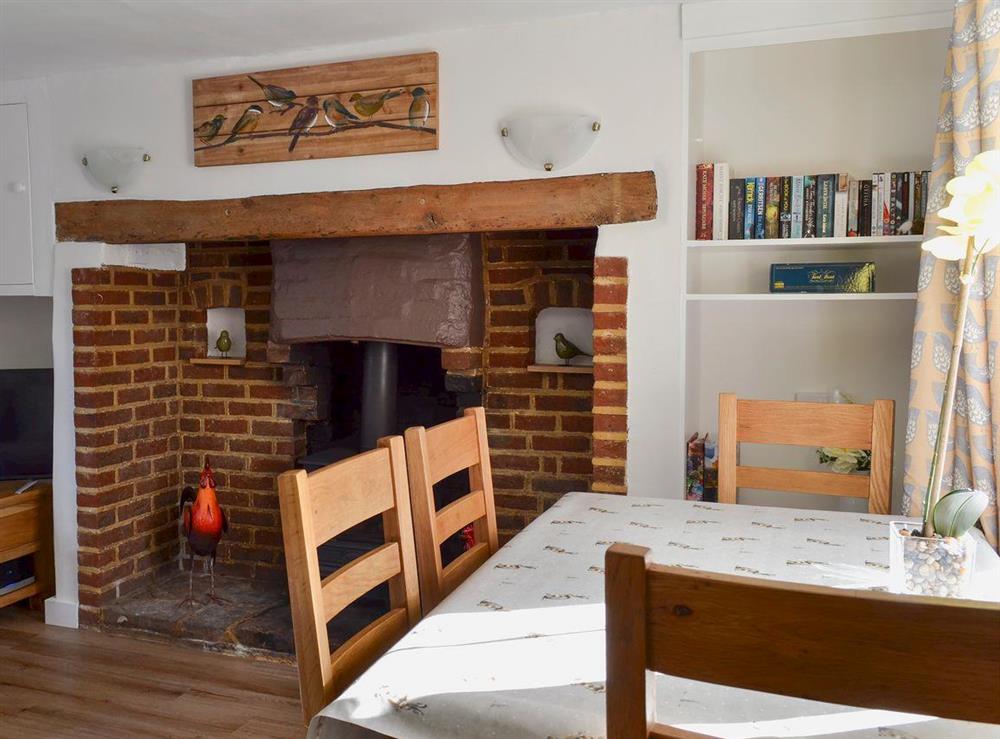 Charming fireside dining area at Little Birketts Cottage in Holmbury St Mary, near Dorking, Surrey