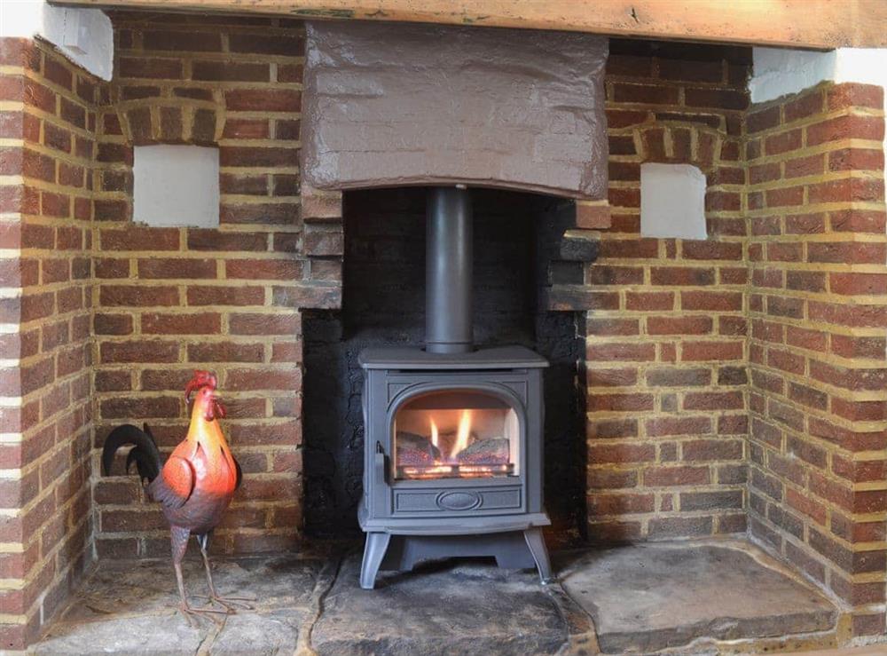 Feature inglenook fireplace at Little Birketts Cottage in Holmbury St Mary, near Dorking, Surrey