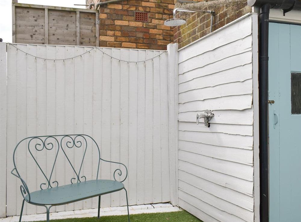 Outdoor shower within courtyard at Little Blue Seaside House in Scarborough, North Yorkshire