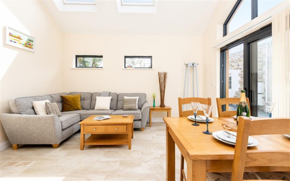 A view of the living dining area from the kitchen at Little Budock in Helford Passage