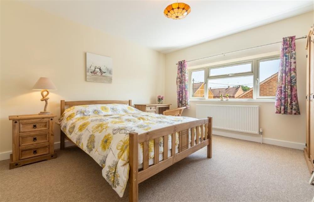 First floor:  Master bedroom with king-size bed at Little Bunting, Heacham near Kings Lynn