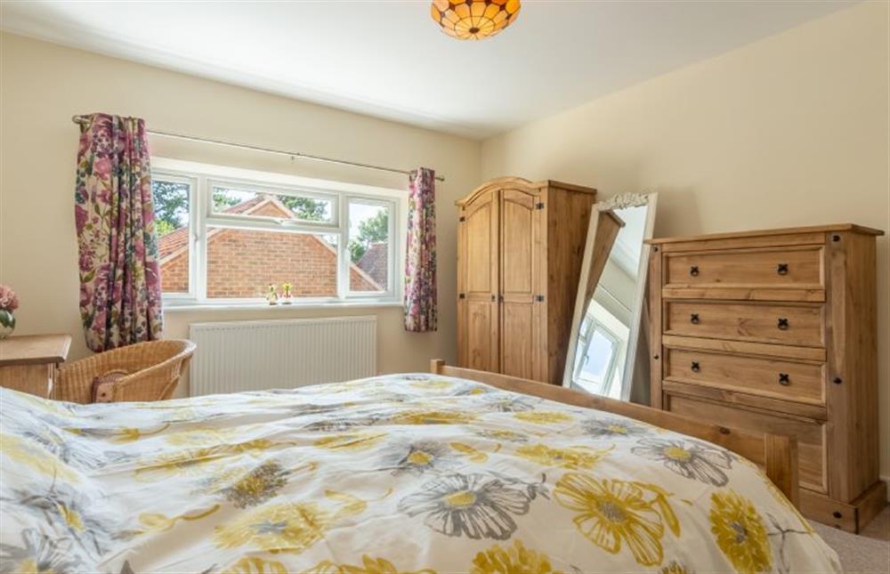 First floor:  Master bedroom with wardrobe and chest of drawers at Little Bunting, Heacham near Kings Lynn