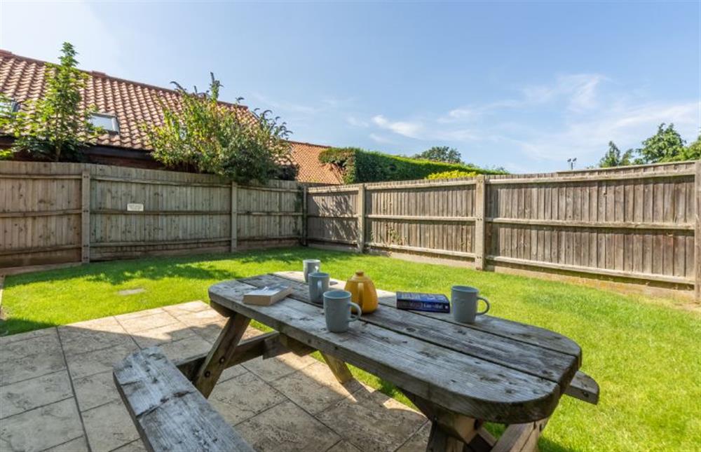 Fully enclosed garden with lawned area and patio at Little Bunting, Heacham near Kings Lynn