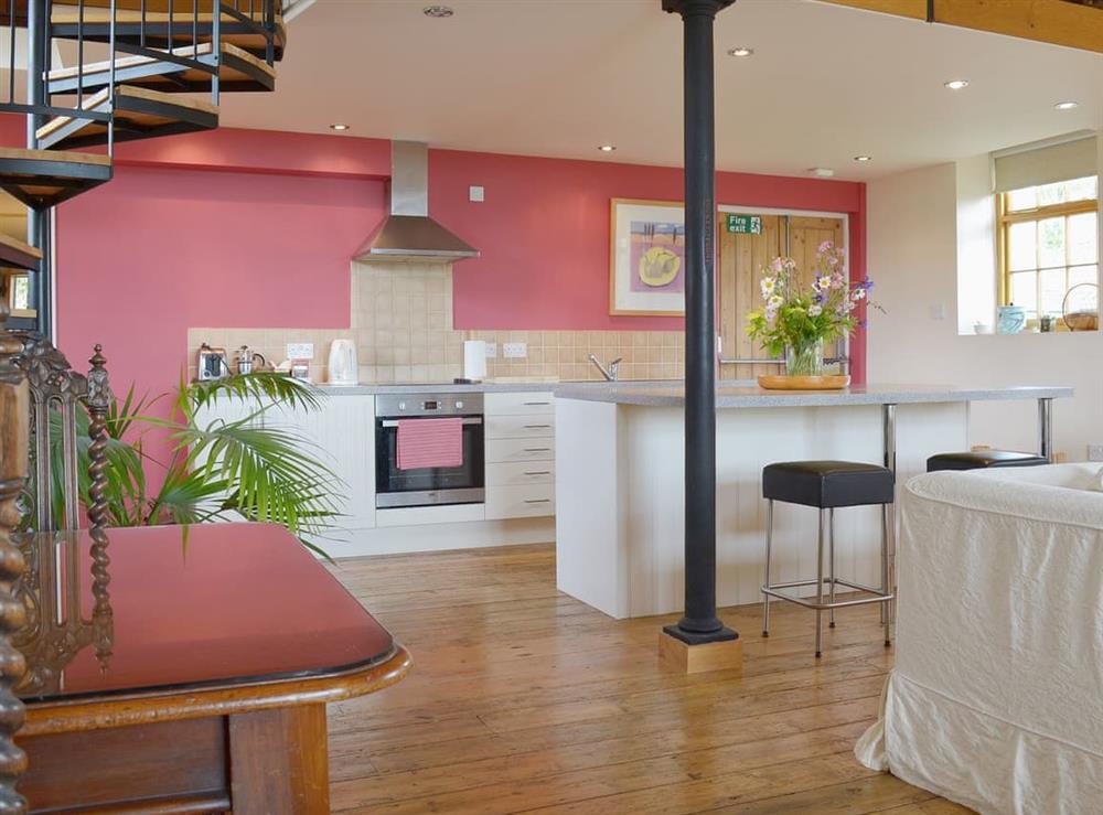 A dining area set off to one side of the open plan space at Little Burcott Loft in Wells, Somerset