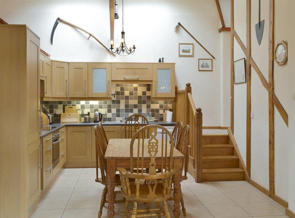Kitchen and dining area with 4 steps to sleeping areas at Orchard View Barn, 