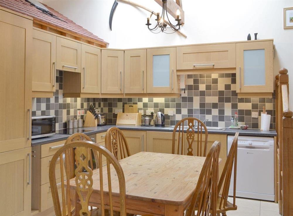 Well-equipped fitted kitchen with dining area at Orchard View Barn, 