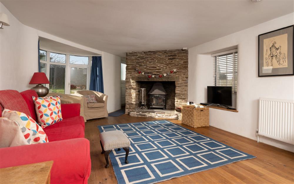 The spacious sitting room with inglenook fireplace. at Little Coombe in Bigbury