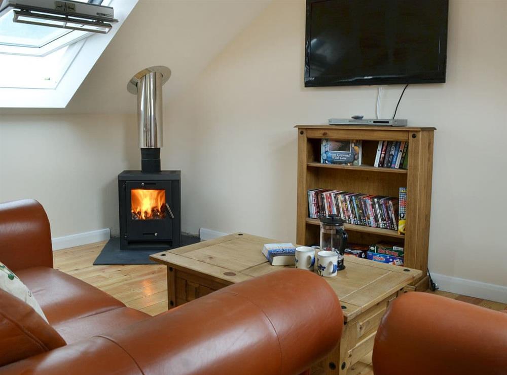 Cosy living area with wood burner (photo 2) at Stonechat Barn, 