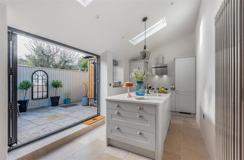 Little Dorset Cottage, Dorset: Bi-folding doors seamlessly connect the kitchen with the courtyard garden