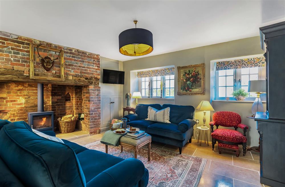 Little Dorset Cottage, Dorset: The cosy sitting room with wood burning stove at Little Dorset Cottage, Blandford