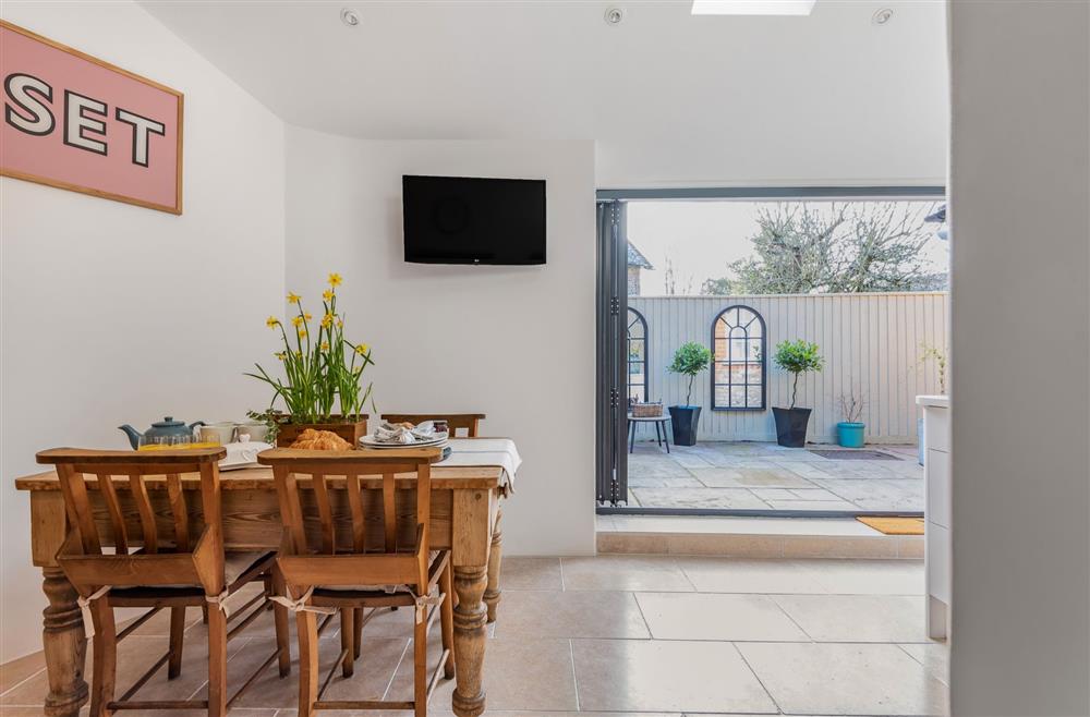 Little Dorset Cottage, Dorset: The dining area opening out to the courtyard garden at Little Dorset Cottage, Blandford