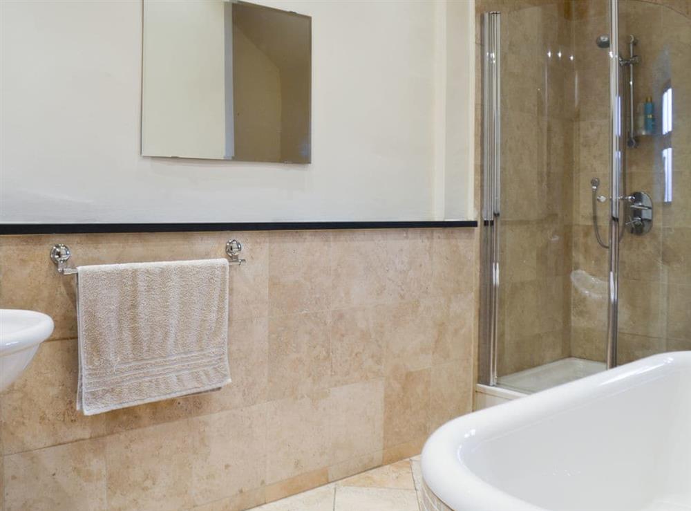 Shower cubicle and bath in the en-suite at Little Foxlow Cottage in Buxton, Derbyshire