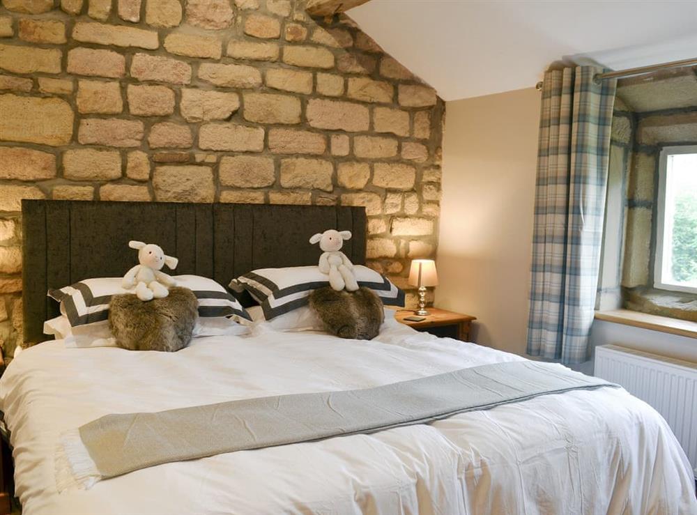 Characterful double bedroom with stone walls at Little Grans Cottage in Ickornshaw, near Cowling, North Yorkshire
