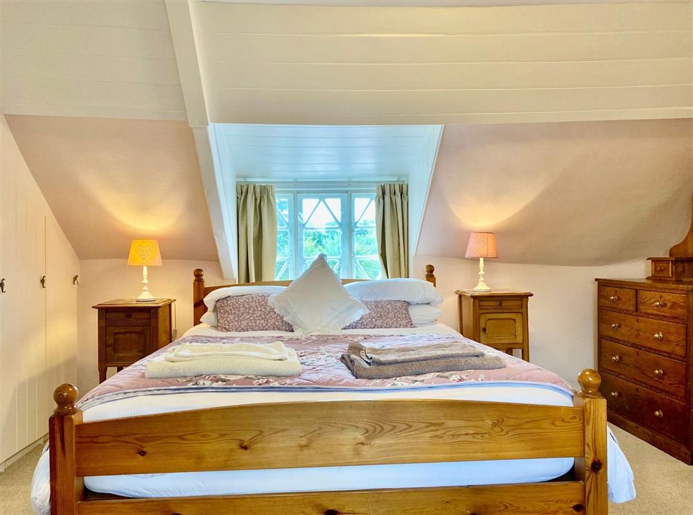 Bedroom one with a 5’ king-size bed and linked to bedroom four next door at Little Halt, Freshwater