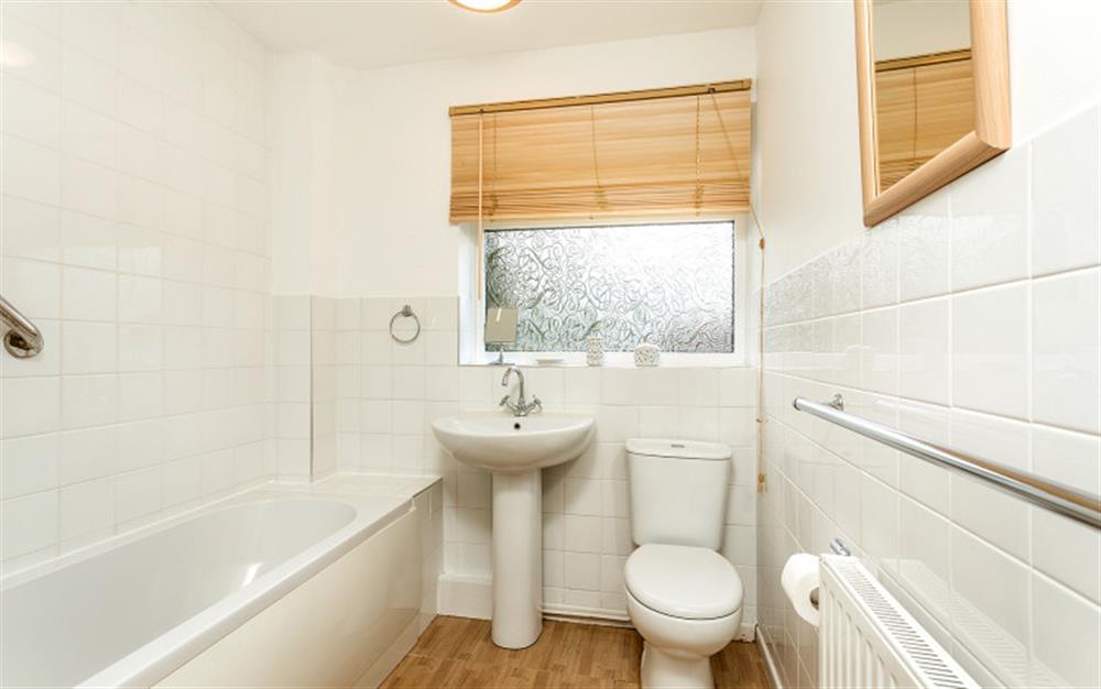 Bathroom with power shower over bath at Little Haven in Colyton